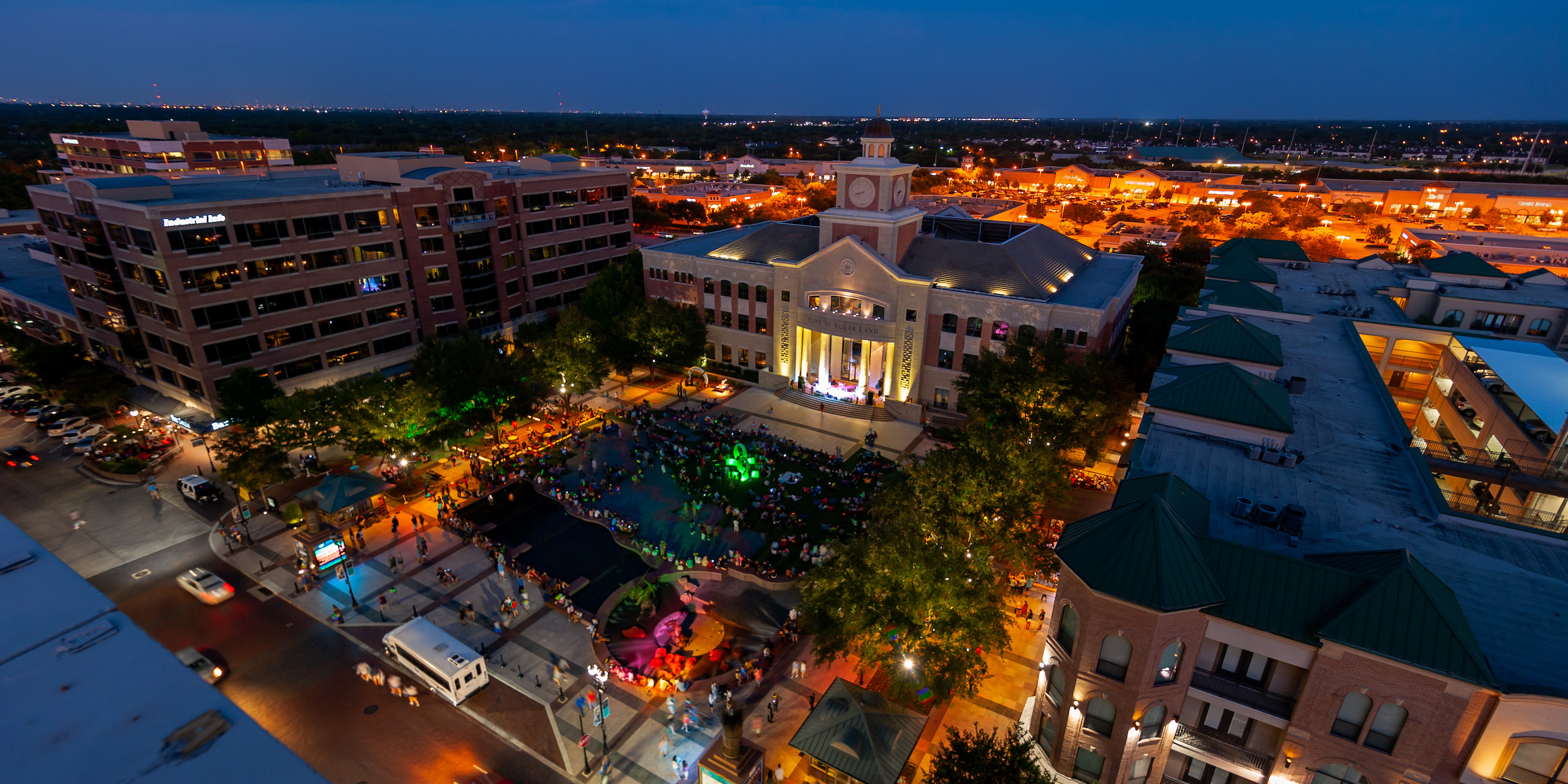 
                  Lonestar Key Master – Professional locksmith services in Sugar Land, Texas, featuring a vibrant nighttime aerial view of Sugar Land Town Square. 24/7 locksmith solutions.